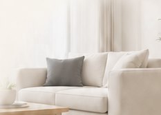 Cream living room with sofa and plant from the approved Anderson Comfort website example